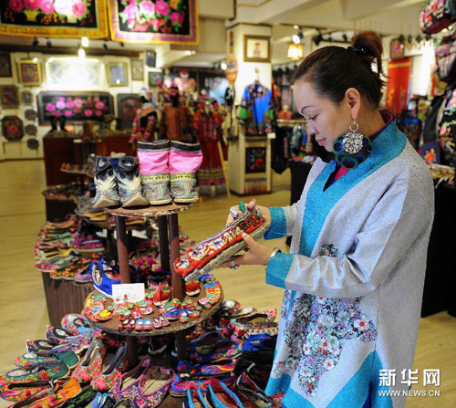 7月21日，顾客在云南省楚雄彝族自治州彝家公社绣品店选购彝族绣品。