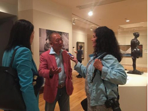 郭庆祥在展览现场接受外媒采访